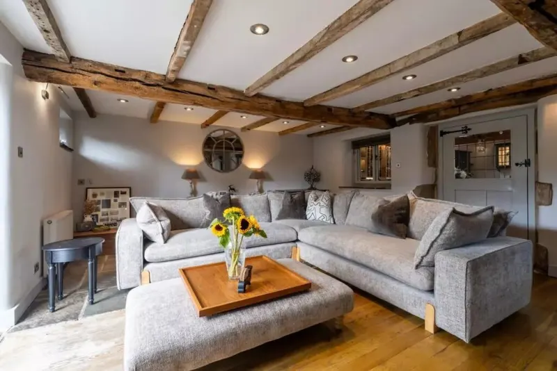 The beamed living room, with sofas the guests are welcome on
