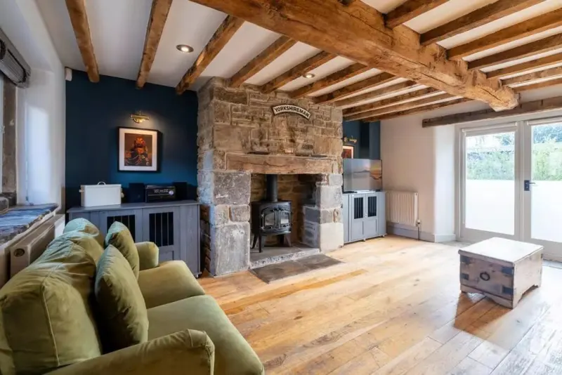 The dog room, with its log burner and stone fireplace